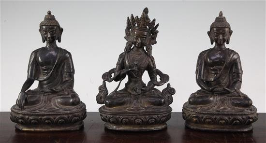 Three A Sino-Tibetan bronze seated figures of Buddhist deities, 20-21cm high